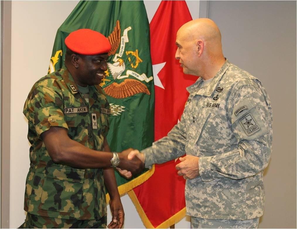 Then-Provost Marshal Pat Akem shakes hands with a US Army Major General