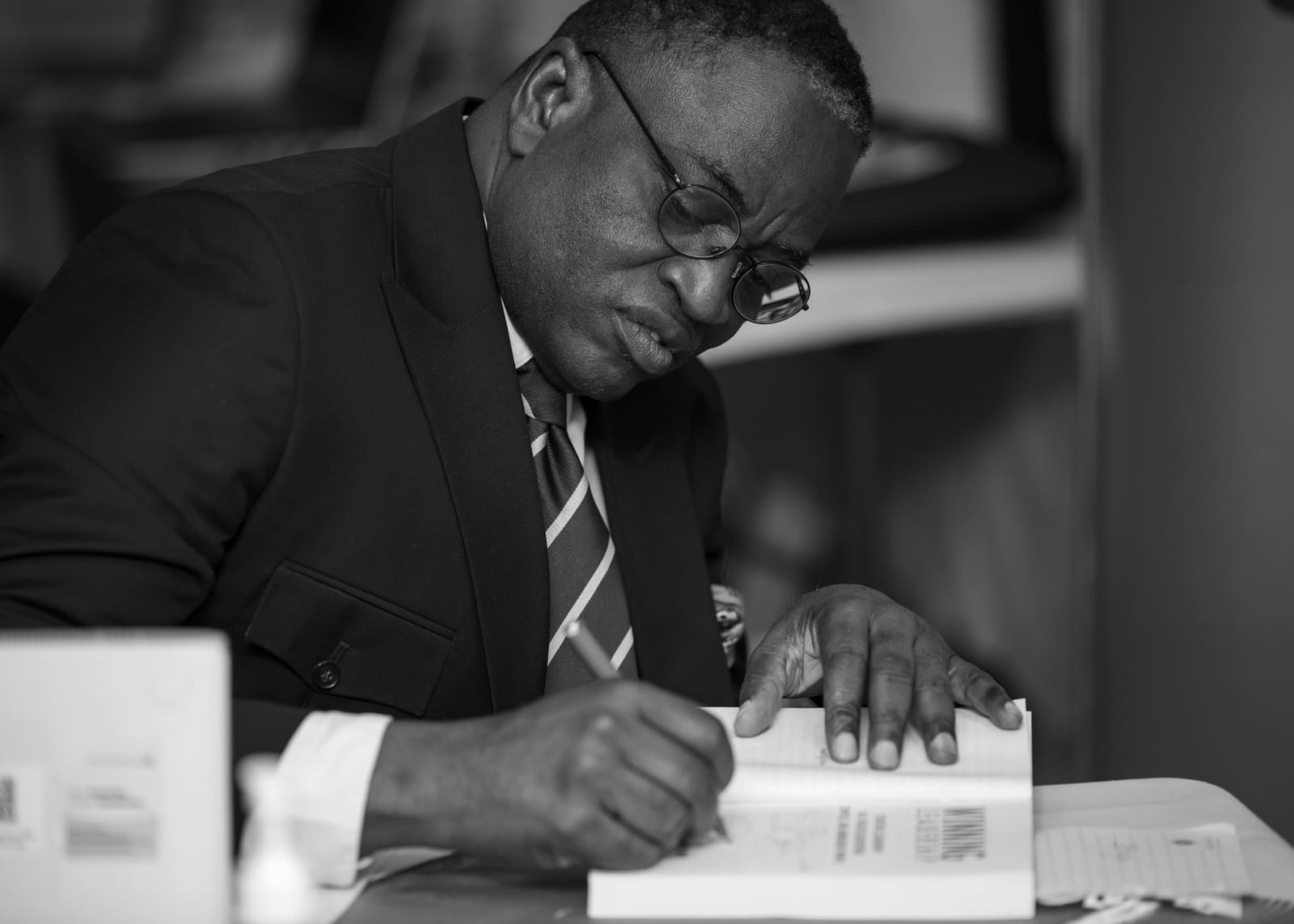 Pat Akem-Vingir signing copies of Winning Leadership