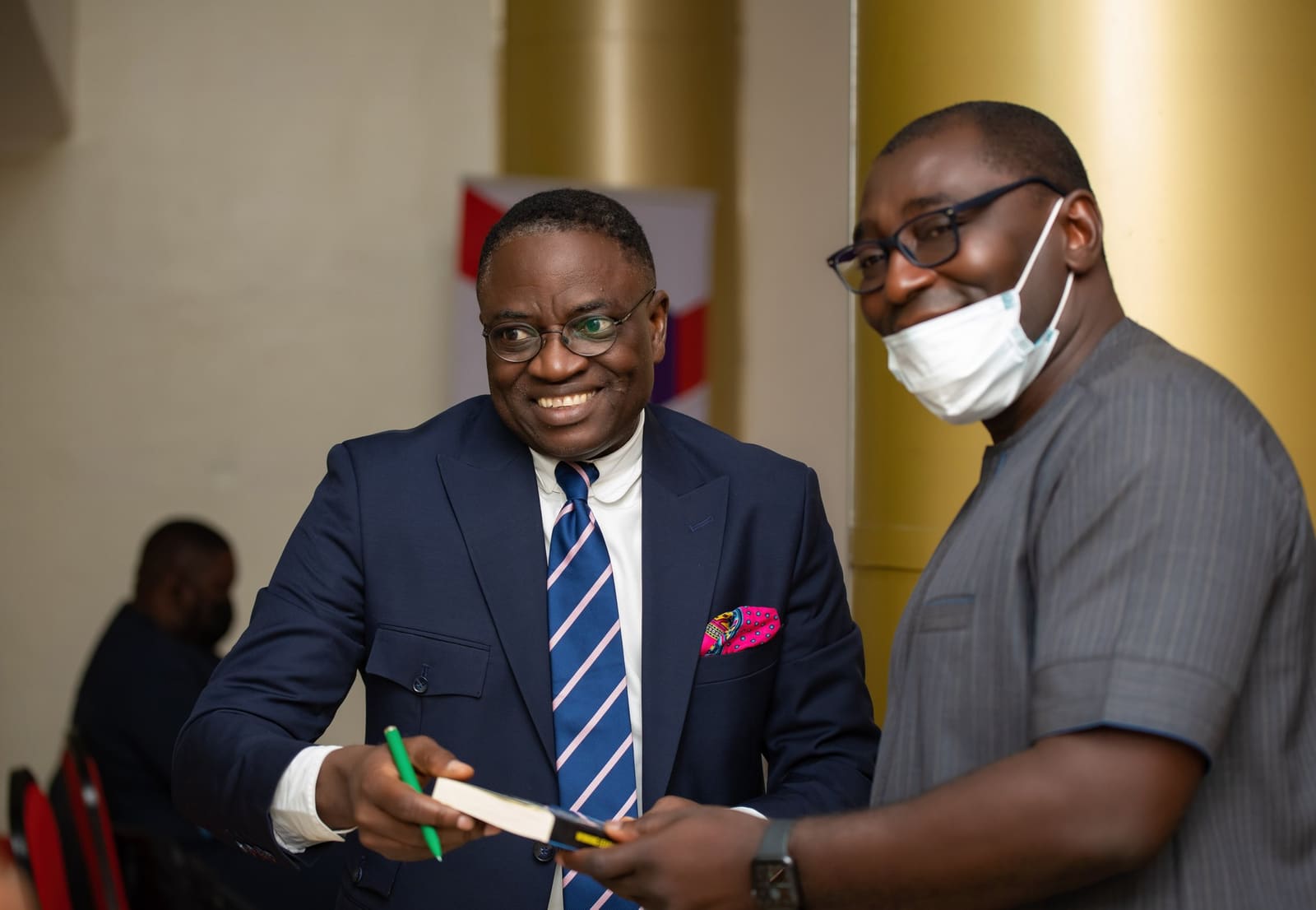 Pat Akem-Vingir greeting a delegate after a session